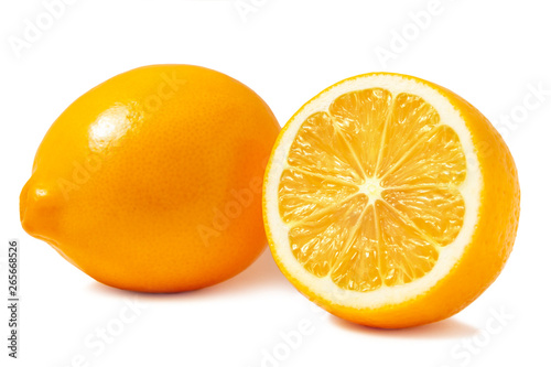 Fresh orange Tashkent lemons or Meyer lemons, one whole and one half isolated on white background with shadow