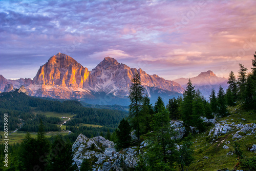 Panoramic view of famous Dolomites mountain peaks glowing in beautiful golden evening light at sunset in summer, South Tyrol, Italy. Artistic picture. Beauty of mountains world