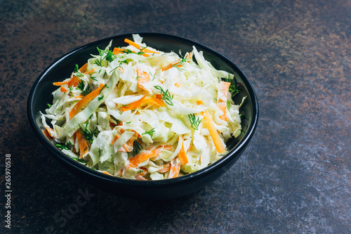 Traditional cole slaw salad in a black bowl