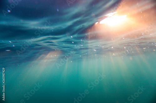 Bright beams of sunlight refracting through the surface of the atlantic ocean.