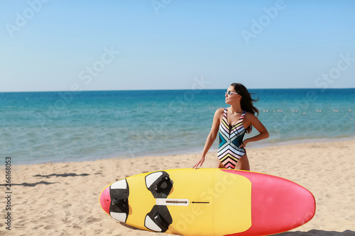 A gorgeous tanned leggy girl posing at a surf in California