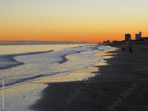 A gorgeous sunset in Galveston Island in Texas while waves gently wash ashore