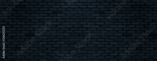 Black color brick wall for brickwork background design . Panorama format .