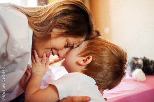 Young happy woman is hugging her son. Mother and child love. Close-up