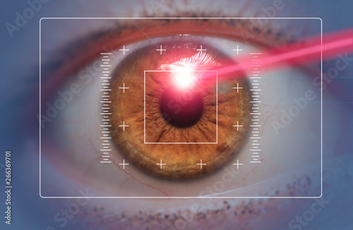 laser eye surgery concept close up of eye with laser beam