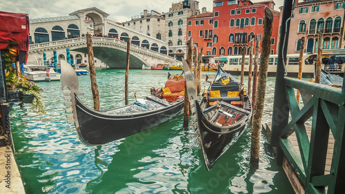 Empty gondolas in front of Rialto Bridge. The bridge is a famous international landmark in Venice, Italy