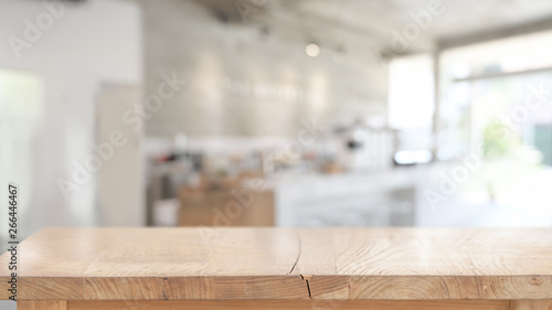 Wood table for product display montage in blurred cafe background