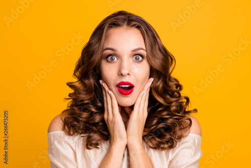 Close up photo frustrated teen cute astonished impressed horrible incredible information gossips rumors guilty worried put fingers cheeks bright pomade face isolated vivid background pastel blouse 
