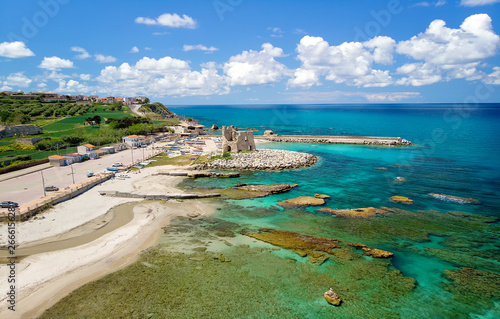 Fishing italian village Briatico in Calabria with turquoise sea and old saracen tower. Drone Panorama - Italy