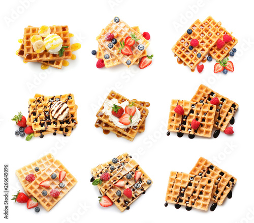 Set of delicious waffles with different toppings on white background, top view