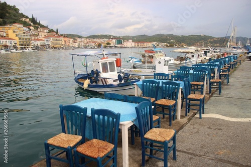Chairs and tables of a restaurant or cafe in the bay of Gythion, Laconia, Peloponnese, Greece. South-east Europe.