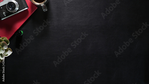 Header web concept, Dark leather desk with vintage camera, red notebook and copy space