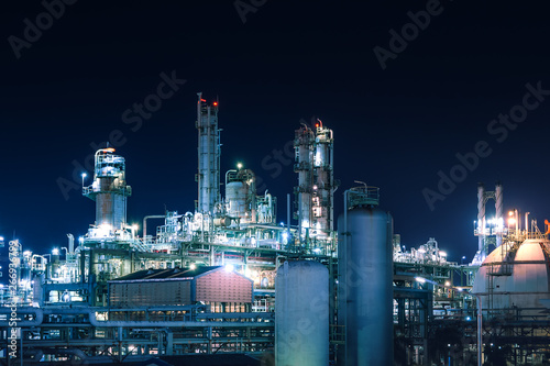 Manufacturing of petroleum industrial plant with gas tanks at night