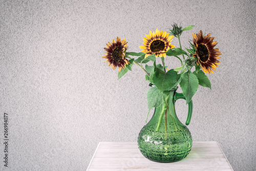 Bouquet of sunflowers in a green vase