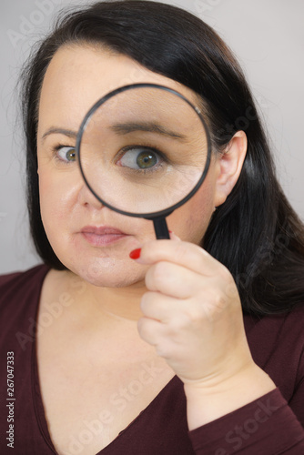 Adult woman with magnifying glass