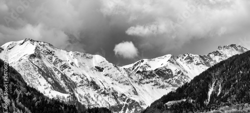 black and white panorama mountain landscape with snowcapped peaks and expressive cloudscape