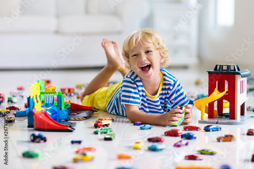 Kids play with toy cars. Children playing car toys