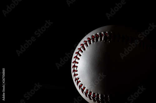 A white baseball with dark background