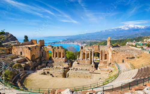 Ancient Greek theatre in Taormina on background of Etna Volcano, Italy