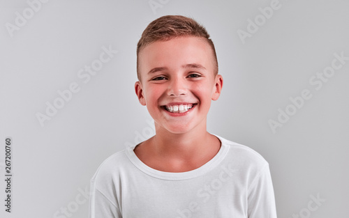 Cute boy on a gray background