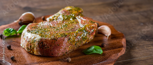 Raw Pork Loin chops marinated meat Steak for bbq on wooden table background