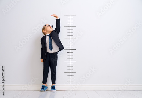 Kid is measuring the growth