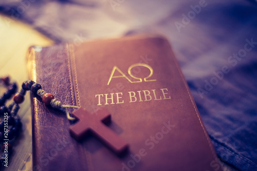 Holy bible and rosary: Christian bible and rosary on a wooden desk