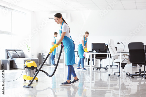 Team of janitors cleaning office