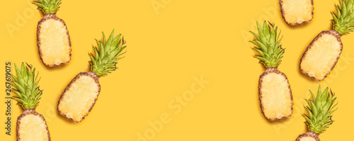 Fresh half sliced pineapple on yellow background. Top View. Copy Space.