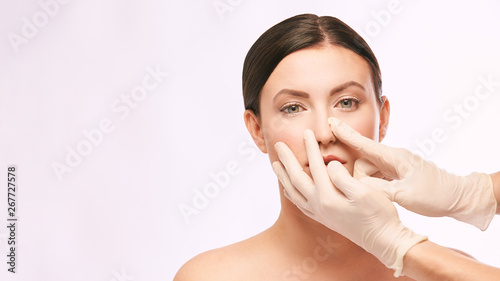 Female derma rejuvenate treatment. Doctor in gloves touch woman face. Cosmetology pretty portrait. Facial injection patient