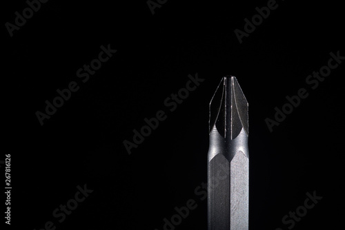 Philips-head screwdriver on a black background