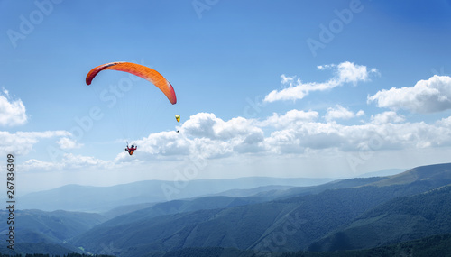 Paraglider in the blue sky.