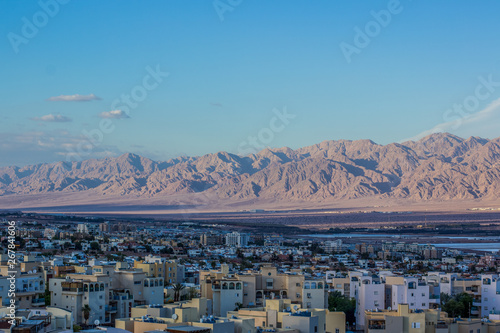 Jewish Israeli city street Eilat aerial scenic landmark photography from above with view on a buildings foreground and sand stone rocky mountain perspective horizon ridge background 