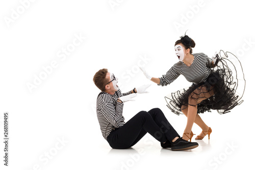 Smiling mimes in striped shirts. Man and woman dressed as actors of pantomime theater isolated on white background