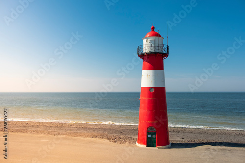 Traditional red white steel lighthouse in Westkapelle, Netherlands.