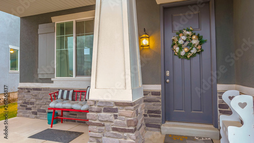 Panorama Gray front door on the facade of a home decorated with bauble and flower wreath