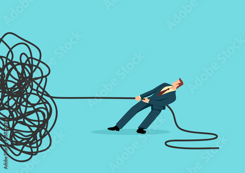 Businessman trying to unravel tangled rope or cable