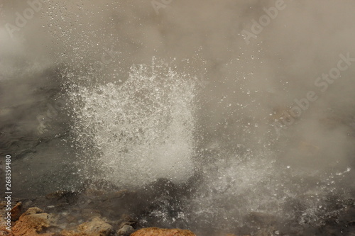 steam rising and rolling from the bubbling boiling water of a volcanic hot spring in a beautiful national park near Pai, Northern Thailand, Southeast Asia