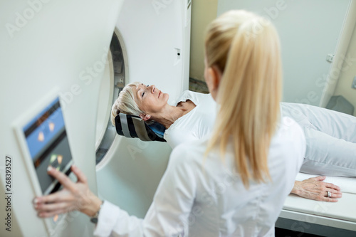 Mature female patient undergoing for CT scan examination in the hospital.