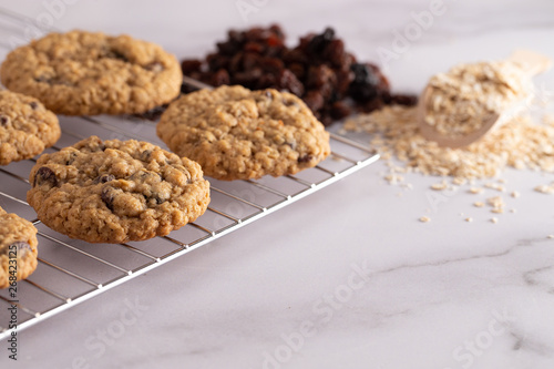 Cinnamon Raisin Oatmeal Cookies with Ingredients on a Marble Counter