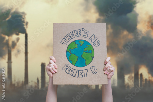Climate change manifestation poster on an industrial fossil fuel burning background: there is no planet b