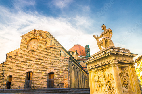 Basilica di San Lorenzo Cappelle Medicee chapel and Giovanni delle Bande Nere monument on Piazza di San Lorenzo square in historical centre of Florence city, blue sky white clouds, Tuscany, Italy