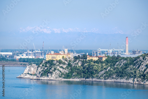 Castle Duino and harbor Monfalcone with mountains alps in Italy