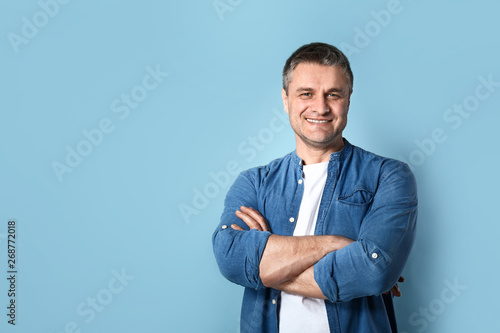 Portrait of handsome mature man on color background