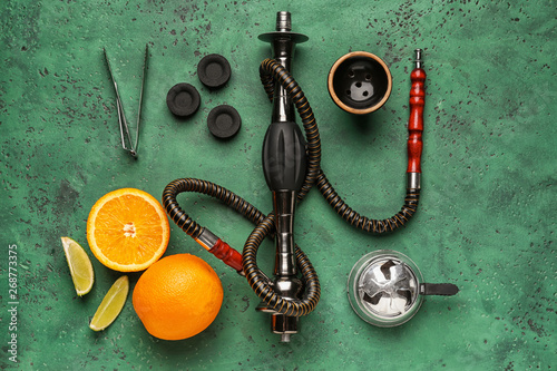 Parts of hookah and fruits on color background