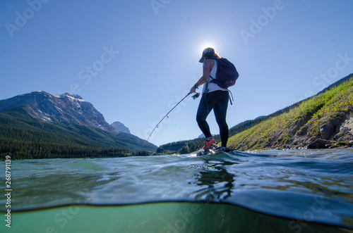 girl fishing on a lake in banff national park canada