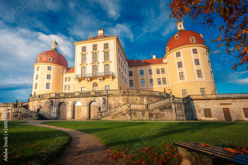 Famouse Moritzburg Castle near Dresden lit by the setting sun in the autumn. Saxony, Germany, Europe. Creative image. Awesome nature landscape with rerfect sky. Popular Places for photographers