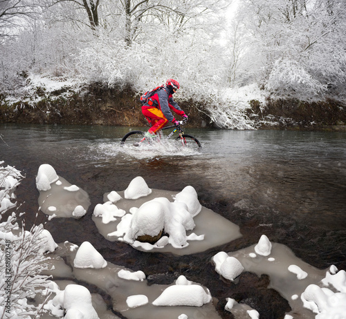 Race by mountain bike on icy water