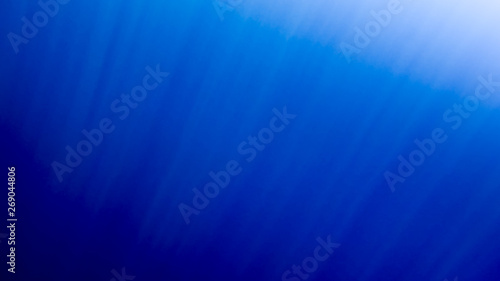 Amazing under water image of swimming fishes and shining sun rays throught the water surface