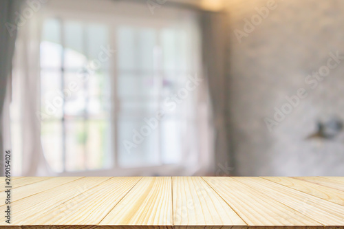 Empty wood table top on hotel resort living room interior design with large windows abstract blur background for product display